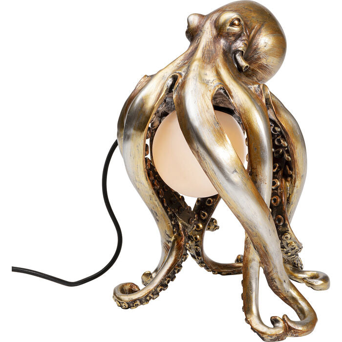 Octopus is a table lamp that not only exudes a golden glow, but is also a designer object with a stunning effect. Hand -made with attention to every detail, it shines with light milk light, making a feeling of coziness and warmth. The use of resin introduces antique elements. The octopus placed in the bedroom on the bedside table introduces a note of avant -garde to modern interiors. It will perfectly complement the Scandinavian style salons, giving them uniqueness.