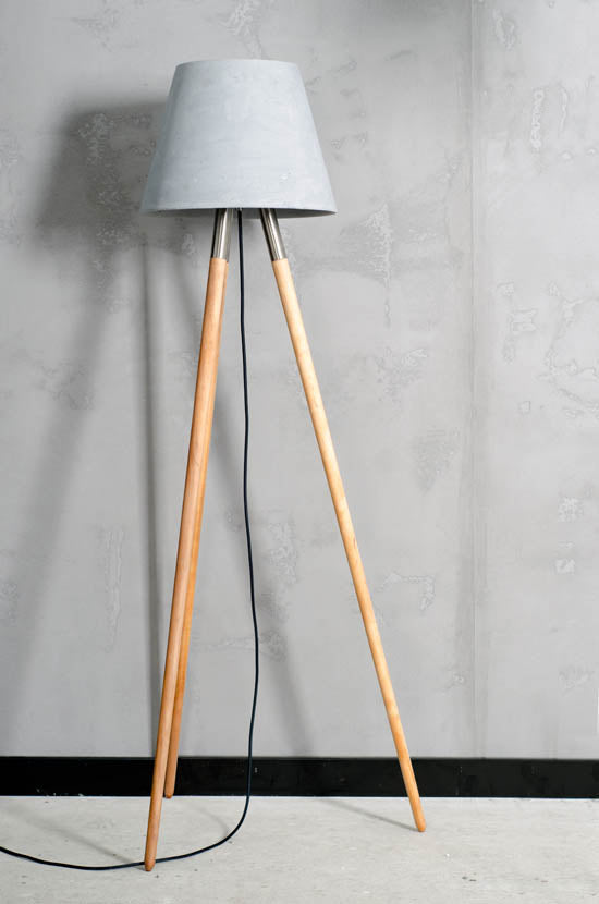 The concrete Kopa Floor lamp is an original addition to the interior. It looks very simple and elegant, thanks to three wooden legs. In addition, each copy of this lamp is unique because it is made by hand. The steel structure, which connects the top with the bottom and freely hanging cable, create details that make the whole look amazing. It is not only a source of lighting, but also an interesting addition.